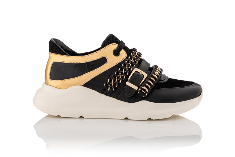 Gender Neutral black and gold leather sneaker with white sole